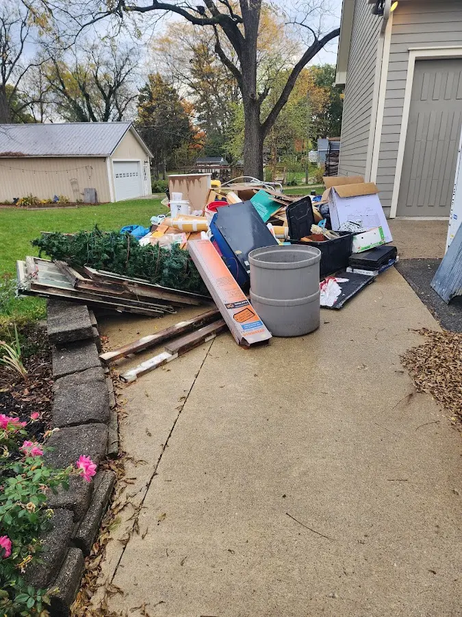 Dumpster being loaded with debris for 12 Yard Dumpster Rental in Mukwonago
